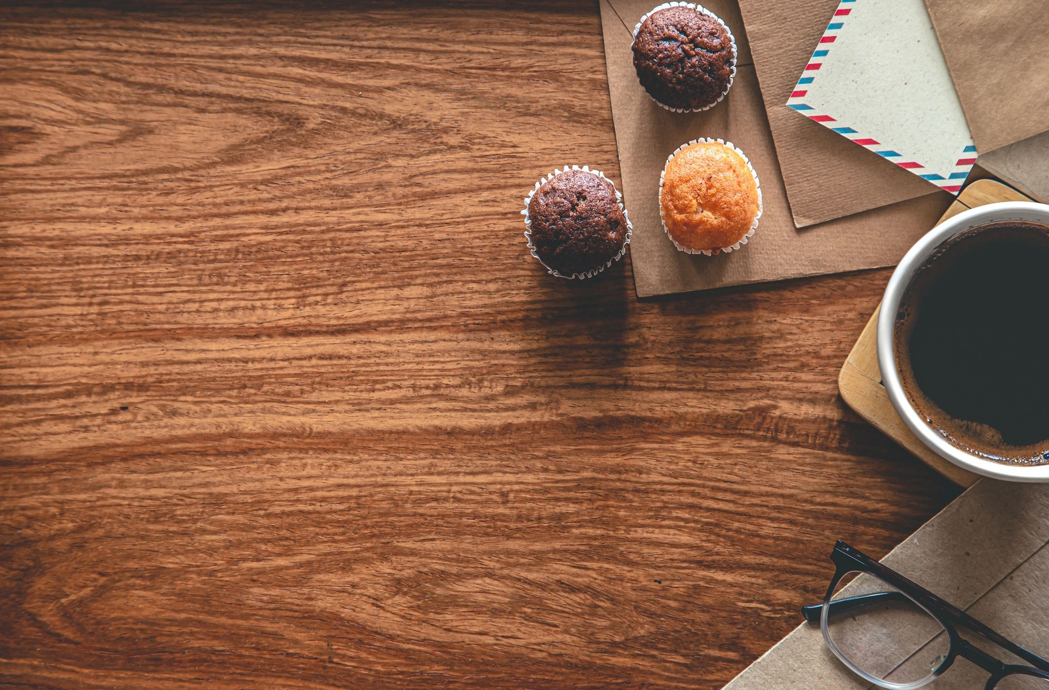 Vintage envelopes and coffee on a wooden desk